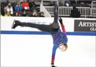  ?? TONY AVELAR AP ?? Ilia Malinin performs a handstand during the men’s free skate at the U.S. Figure Skating Championsh­ips.