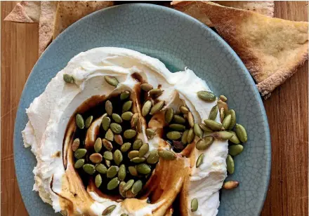  ?? LUCY CORRY ?? Why would you want to throw together reduced cream and onion dip when you could enjoy this labne with pomegranat­e molasses and pumpkin seeds?