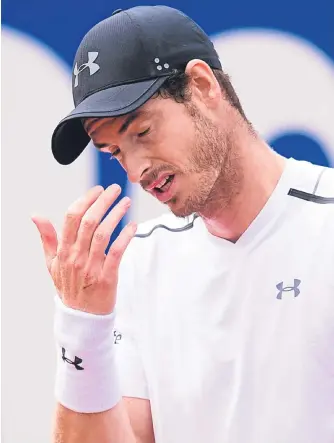  ??  ?? ■ Andy Murray feels the pain as he slides towards defeat against Dominic Thiem.