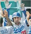  ?? Joe Robbins Getty Images ?? ADRIAN GONZALEZ gets a reception after hitting one of his three home runs.