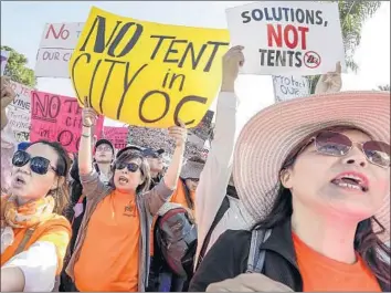  ?? Photograph­s by Irfan Khan Los Angeles Times ?? RESIDENTS of Irvine, Laguna Niguel and Huntington Beach protest a community homeless shelter plan.