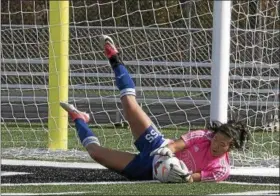  ?? JEN FORBUS — THE MORNING JOURNAL ?? Bay goalkeeper Gigi Merk makes a diving save against Mansfield Madison in a D-III regional final.