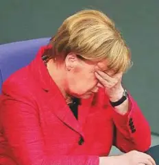  ?? Bloomberg ?? Angela Merkel, Germany’s chancellor, reacts in the lowerhouse of the German Parliament in Berlin yesterday. Merkel says she’s ready to face voters again.