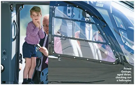  ??  ?? Prince George, aged three, checking out a helicopter