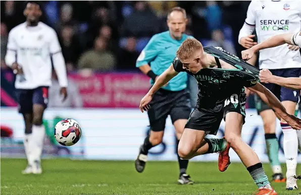  ?? ?? Bolton’s George Johnston gets to grips with Rovers goalscorer Josh Coburn during Friday night’s League One game