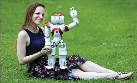  ??  ?? WTF: Nicole Robinson is a psychology PhD student at QUT who is working with robots. She is pictured here with “Andy”. PHOTO: ANNETTE DEW