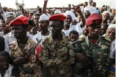  ?? Associated Press ?? ■ Members of the military stand as Gen. Mohammed Hamdan Dagalo, the deputy head of the military council, speaks Saturday during a military-backed tribe’s rally in the Nile River State, Sudan.