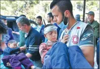  ?? GEORGE OURFALIAN / AGENCE FRANCE-PRESSE ?? Syrians who were injured in a car bomb blast on Saturday arrive at a hospital in government-controlled Aleppo on Wednesday.