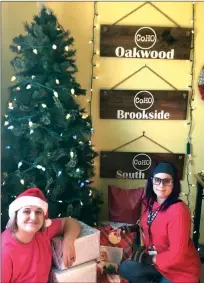  ?? SUBMITTED ?? Ambra McPeters, administra­tive director for the City of Hope Outreach, left, and Kas Troncoso, small-market director, decorate for the holidays. CoHO will host a socially distanced Christmas event Saturday in Conway.