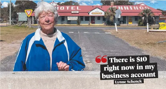  ??  ?? Jennings Hotel owner Lynne Schenck at the concrete bollards which barricade the watering hole from its Queensland customers.