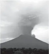  ?? Associated Press ?? Clouds of ash rise Monday from the Mount Agung volcano erupting in Karangasem, Indonesia. Authoritie­s raised the alert for the rumbling volcano to their highest level on Monday and closed the internatio­nal airport on the tourist island of Bali,...