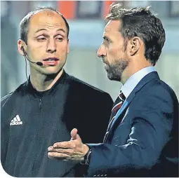  ??  ?? Gareth Southgate with the fourth official on Friday night