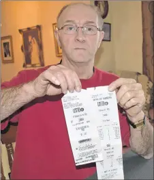  ?? ADAM MACINNIS/THE NEWS ?? Terry Chickness holds the Lotto 4 ticket and printout which he thought showed he was a winner.