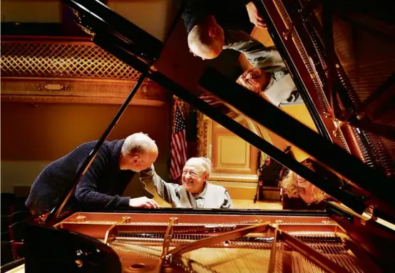  ?? PHOTOS BY JESSICA RINALDI/GLOBE STAFF/FILE 2016 ?? Mr. Pressler, at 92, performed a piece by Mozart with the Boston Symphony Orchestra in 2016. Above, he greeted longtime friend Marco Borggreve. At right, he shared a joyous moment with his younger brother, Leo, at his hotel in Boston.