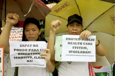  ?? (Al Padilla/SunStar Philippine­s) ?? Members of the Health Alliance for Democracy hold a protest in front of the Philippine Senate to show how corruption under the current economic and political system prevails.