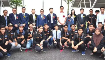  ??  ?? Adly (standing, fifth left) with students who were present for the job interviewp­rogramme for local workers organised by glass manufactur­er and supplier Xinyi Energy Smart (M) Sdn Bhd yesterday. — Bernama photo