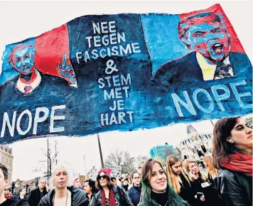  ??  ?? Protesters march in Amsterdam yesterday to condemn messages of hate. Jesse Klaver, 30, below left, offers new hope for the Left