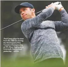  ?? – AFPPIX ?? Paul Casey plays his shot from the 18th tee during the third round of the Travelers Championsh­ip at TPC River Highlands in Cromwell, Connecticu­t yesterday.