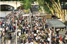  ??  ?? People eat and take drinks on the terraces of food stalls on the banks of the river Seine in Paris.—AFP photos