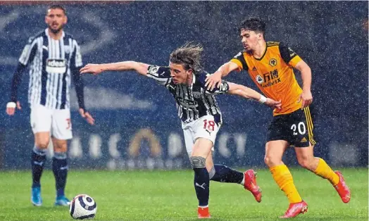  ?? —aFP ?? No time to waste: West Brom midfielder Conor Gallagher pulling away from Wolves midfielder Vitinha (right) during the english Premier League match.