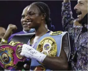  ??  ?? Claressa Shields holds her championsh­ip belts after her win on Friday night