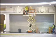  ?? Erik Trautmann / Hearst Connecticu­t Media ?? Constructi­on workers work on a SoNo Collection entry to Nordstrom on Tuesday in advance of the Norwalk mall’s opening date on Oct. 11.