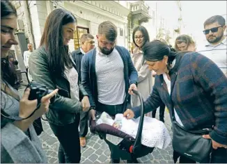  ?? ?? YARYNA BIDYUK, second from left, gave birth to Mativii in Poland after fleeing for safety in the war’s first days. Her soldier husband, Taras, carrying the bassinet, finally met his son last week.