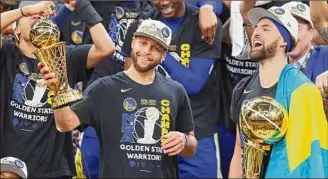  ?? Adam Glanzman / Getty Images ?? NBA Finals Most Valuable Player Stephen Curry, center, and Klay Thompson, right, of the Warriors celebrate after they won their fourth title in eight years on Thursday.