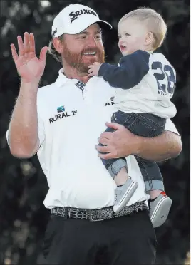 ?? Ryan Kang The Associated Press ?? J.B. Holmes celebrates with son Tucker on the 18th green Sunday after winning the Genesis Open at Riviera Country Club by one stroke over Justin Thomas.
