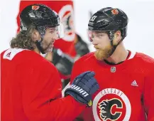  ??  ?? Jaromir Jagr, left, chats with Sam Bennett during practice on Thursday. Bennett said he’s thrilled to be playing on a line with a hockey legend.