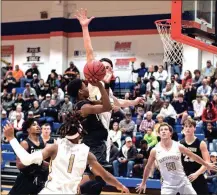  ?? TIM GODBEE / For the Calhoun Times ?? Calhoun’s Caleb Boone (center) goes up for a shot in traffic during the second half against Cartersvil­le on Wednesday.