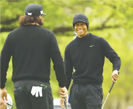  ?? Mike Ehrmann/Getty Images ?? Tiger Woods, right, got a practice round in with Pat Perez Tuesday at the Bethpage Black course on Long Island, N.Y., in preparatio­n for the 2019 PGA Championsh­ip.