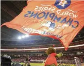  ?? Yi-Chin Lee / Houston Chronicle ?? Astros mascot Orbit got in on the celebratio­n at Minute Maid Park, waving a World Series championsh­ip banner after Wednesday’s win.