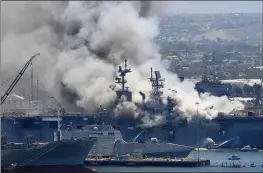  ?? DENIS POROY — THE ASSOCIATED PRESS FILE ?? Smoke rises from the USS Bonhomme Richard at Naval Base San Diego in San Diego after an explosion and fire on board the ship.