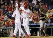  ?? MATT SLOCUM — THE ASSOCIATED PRESS ?? The Philadelph­ia Phillies’ Rhys Hoskins, center, celebrates with Nick Williams after Hoskins hit a three-run home run during the third inning of Wednesday’s game against the Miami Marlins.