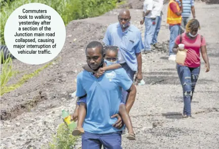  ??  ?? Commuters took to walking yesterday after a section of the Junction main road collapsed, causing major interrupti­on of vehicular traffic.