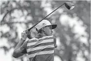  ?? [AP PHOTO/CHARLES KRUPA] ?? Rickie Fowler plays his shot from the 17th tee Thursday en route to a 1-under-par 69 in the first round of the U.S. Open.