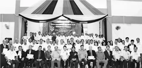  ??  ?? Nyalau (seated front sixth left) and Rayong, on his left, in a group photo with newly appointed and reappointe­d local community leaders for Engkilili state constituen­cy, in a group photo after the presentati­on of certificat­es.