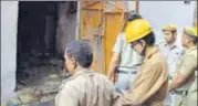  ?? PTI ?? Fire service personnel inspect the building of Raja Park factory where a fire broke out in Sultanpuri.