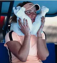  ?? — AFP ?? Blistering heat: Elina Svitolina cools off on the bench during her third-round match against Marta Kostyuk yesterday.