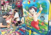  ?? BACHCHAN KUMAR ?? With schools reopening on Monday, a couple shops for school bag at the APMC market. ■