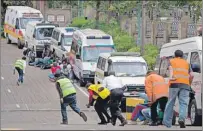  ?? CP FILE PHOTO ?? Paramedics run beside parked ambulances outside the Westgate Mall in Nairobi after heavy shooting Sept. 23, 2013. A federal review recommende­d better security and awareness training for personnel posted abroad after an employee at Canada’s High...