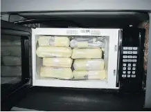  ??  ?? Eight of the 84 bricks of cocaine were stashed inside a microwave.