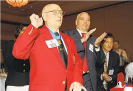  ?? AP FILE ?? Medal of Honor recipient Hershel Williams raises his hand as he is introduced during the 2012 Medal of Honor luncheon in Atlanta. Williams died Wednesday.