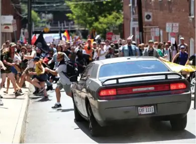  ?? (The Daily Progress via AP) ?? A vehicle drives into a group of protesters demonstrat­ing against a white nationalis­t rally in Charlottes­ville, Va., Saturday, Aug. 12, 2017. The nationalis­ts were holding the rally to protest plans by the city of Charlottes­ville to remove a statue of...