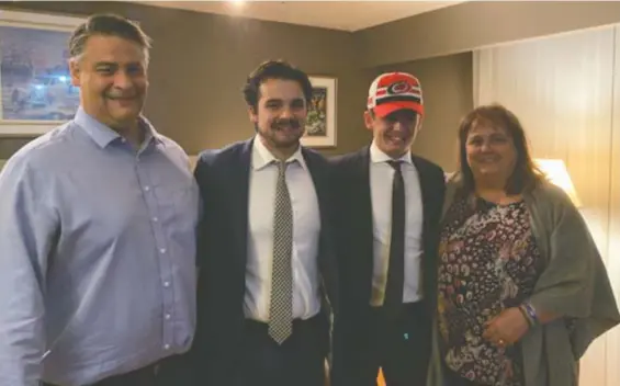  ??  ?? Winnipeg native Seth Jarvis, wearing the Hurricanes cap, celebrates with dad Ray, brother Kayden and mom Tracey after Carolina selected him 13th overall back in October.