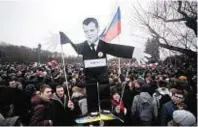  ??  ?? Protesters carry portrait of premier Dmitry Medvedev