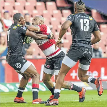  ??  ?? The Lions’ Lionel Mapoe and the Sharks’ Makazole Mapimpi in their match at Emirates Airline Park yesterday.