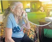  ?? JASON RUITER/STAFF ?? Juanita Fitzgerald, 94, talks on the phone Tuesday, at a Tavares motel.