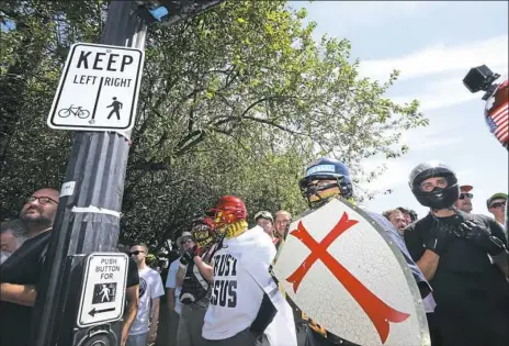  ?? Karen Ducey/Getty Images ?? Right-wing demonstrat­ors hold a rally supporting gun rights and free speech on Saturday in Portland, Ore. The rally was organized by the group Patriot Prayer, also attended by the affiliated group Proud Boys, which drew counterpro­testers and members of the anti-fascist group Antifa.